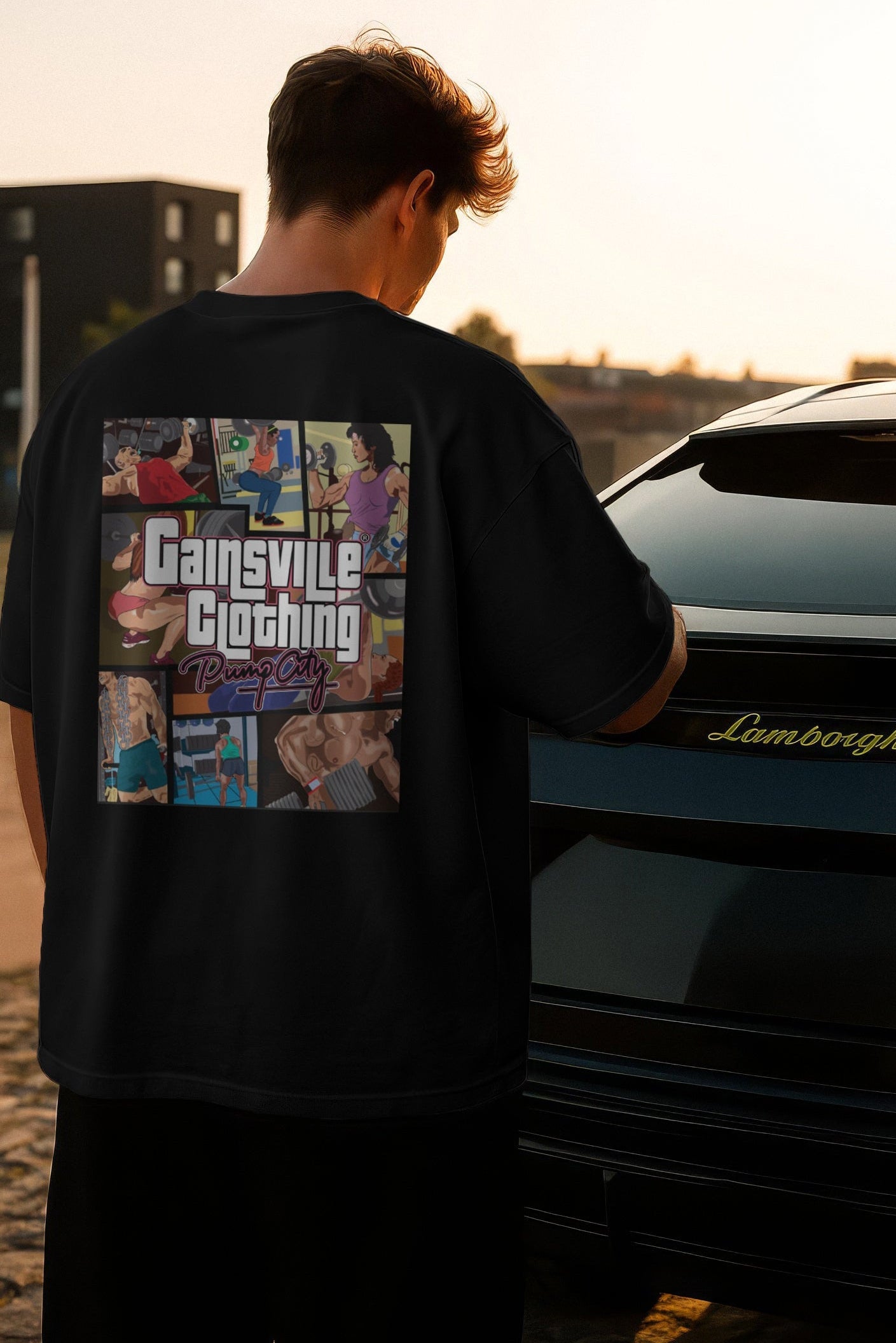 Person wearing a black t-shirt with 'Gainsville Clothing' design, standing next to a Lamborghini.